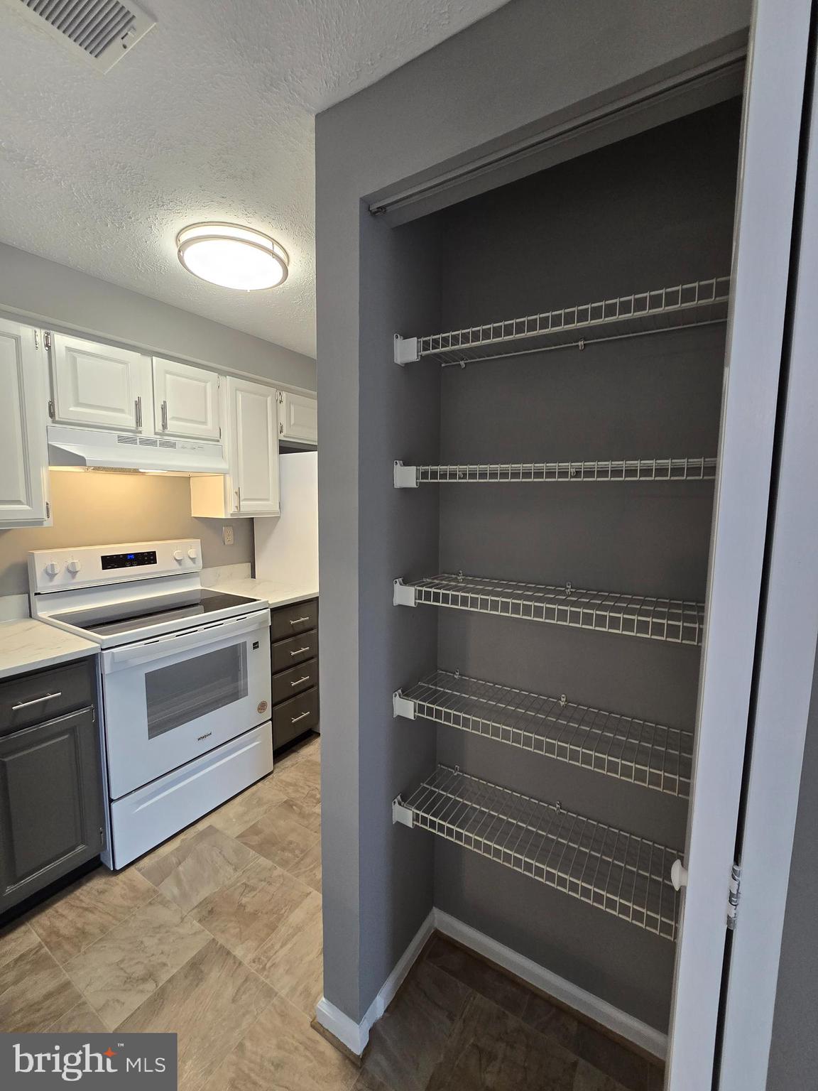 821 Stratford Way, Unit H Frederick, MD 21701 - Photo 18 of 45 a kitchen with a cabinets and a stove top oven