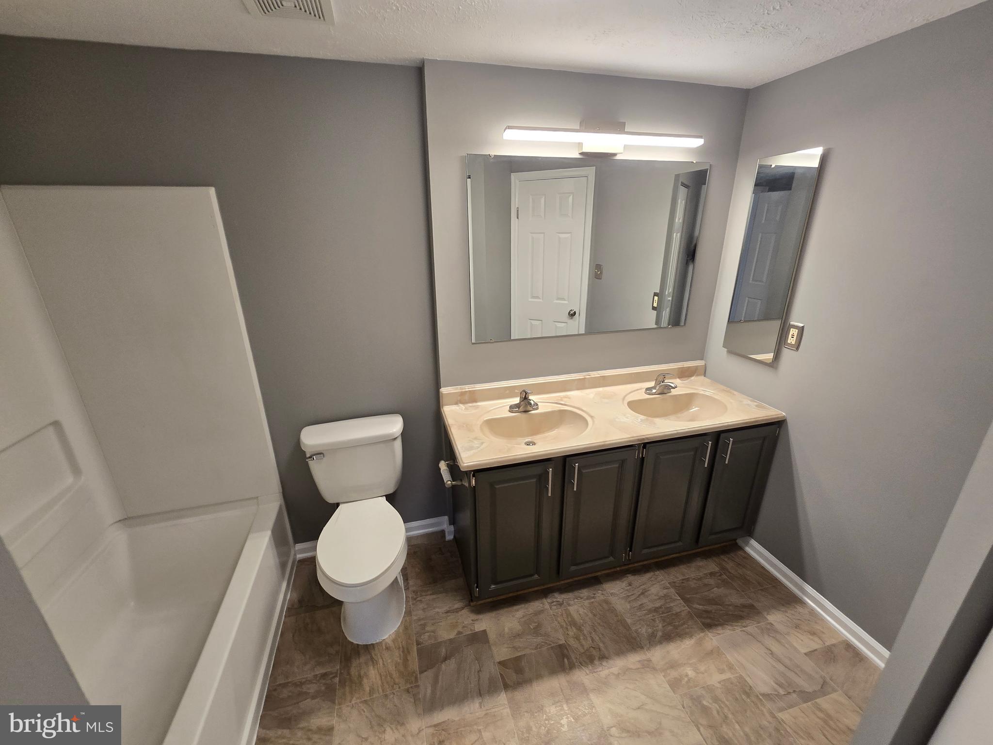 821 Stratford Way, Unit H Frederick, MD 21701 - Photo 35 of 45 a bathroom with a sink a toilet and mirror