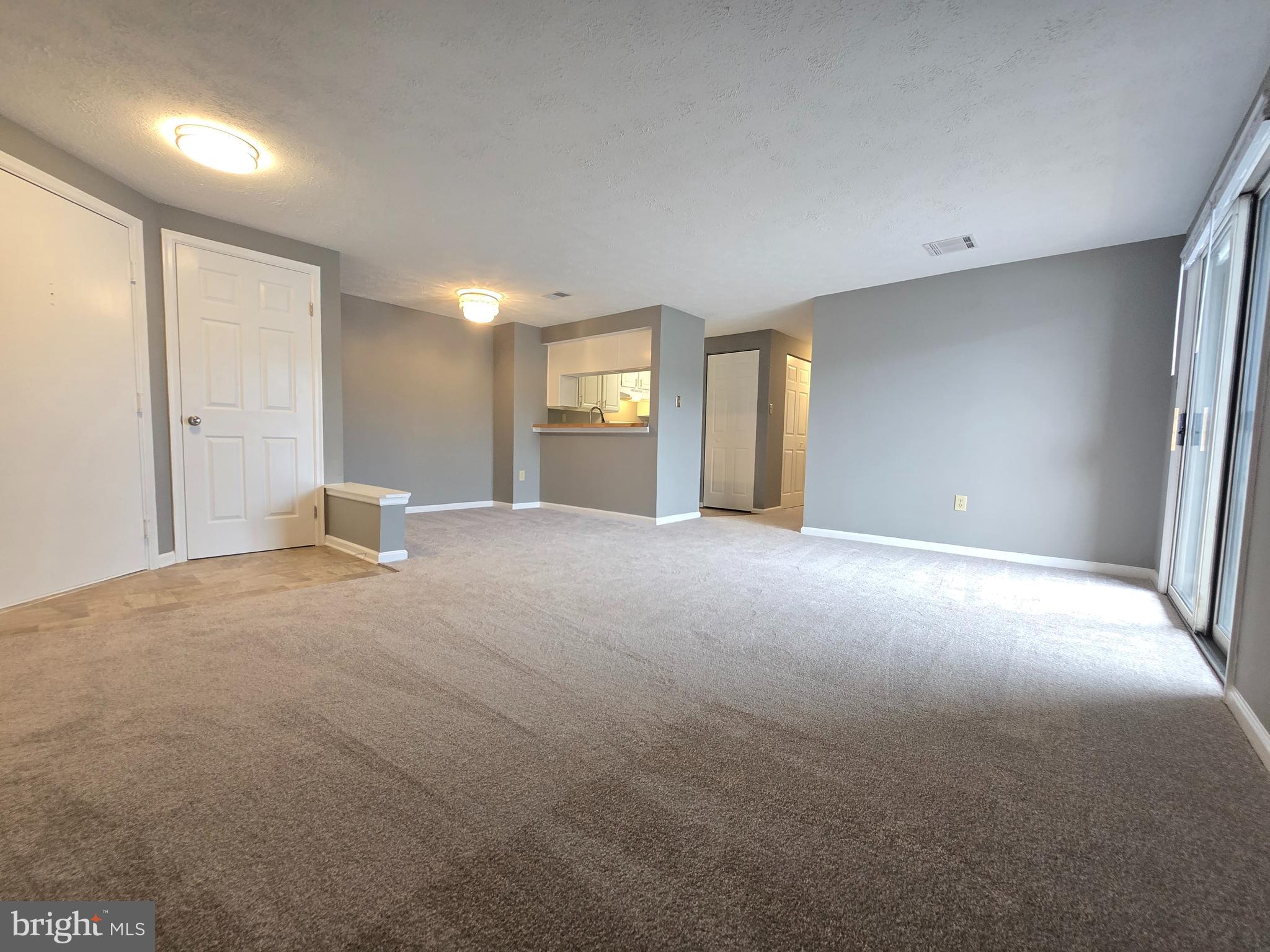 821 Stratford Way, Unit H Frederick, MD 21701 - Photo 4 of 45 a view of a big room with windows and chandelier fan