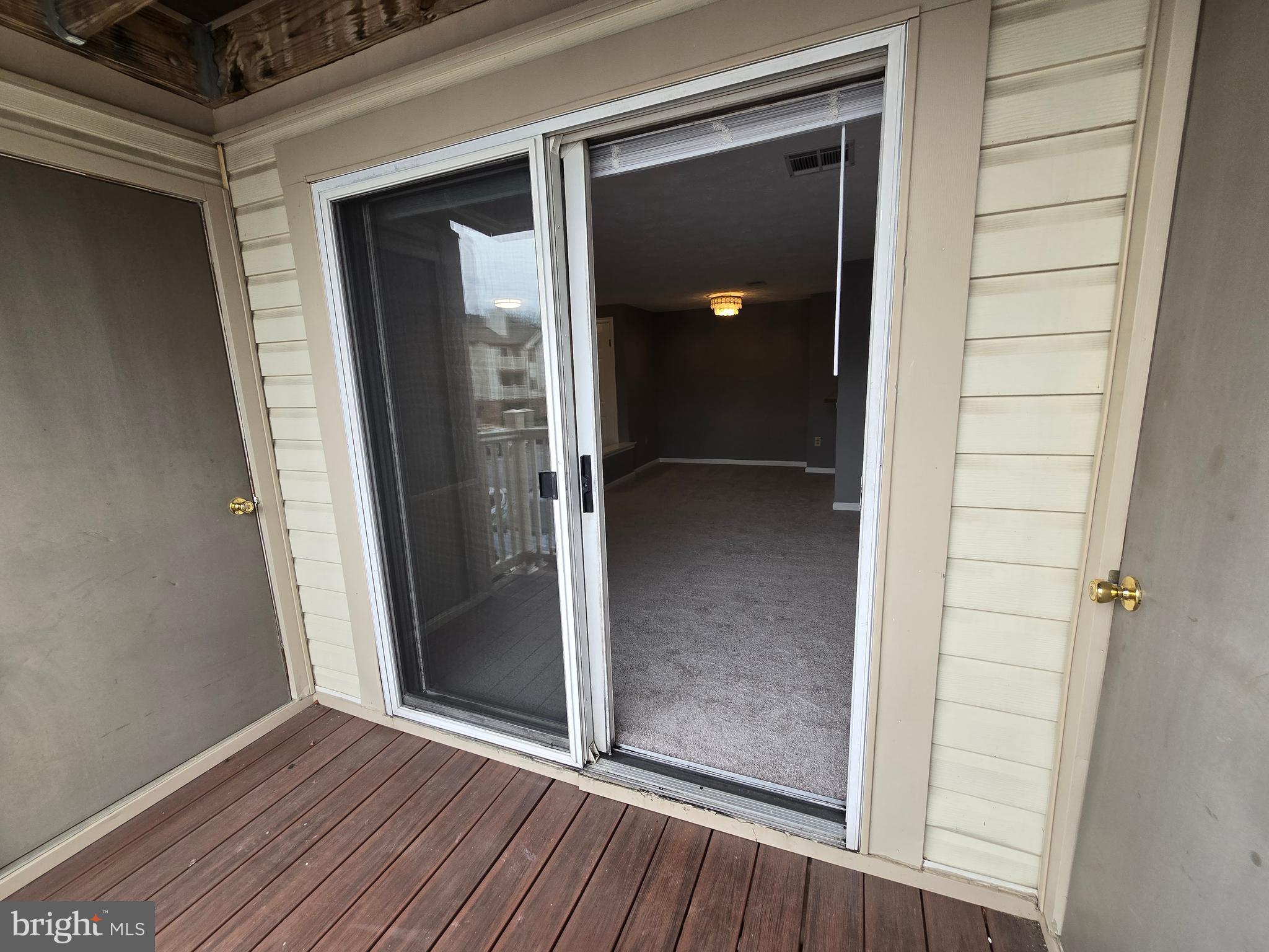 821 Stratford Way, Unit H Frederick, MD 21701 - Photo 43 of 45 an empty room with wooden floor and entrance