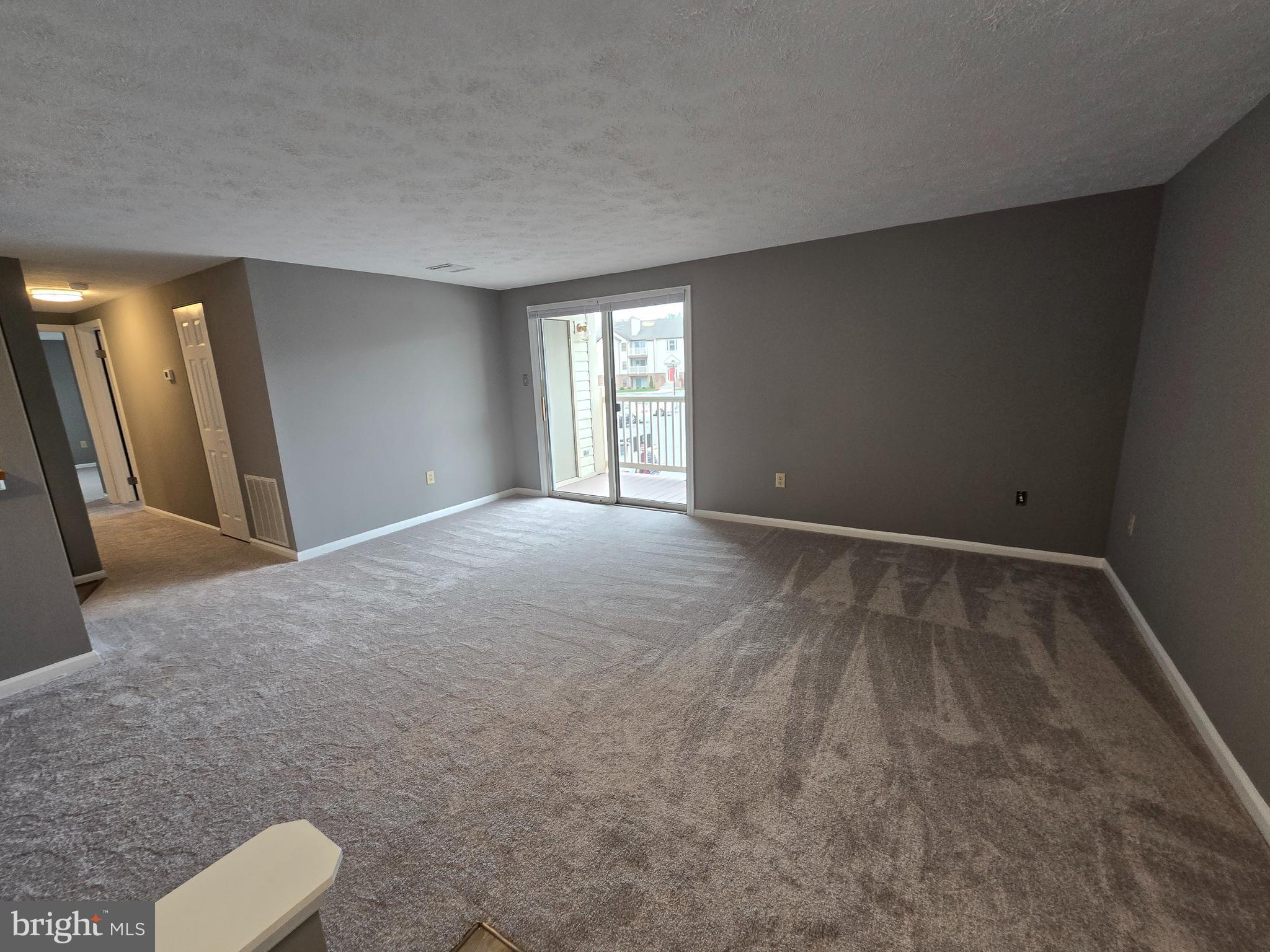 821 Stratford Way, Unit H Frederick, MD 21701 - Photo 8 of 45 a view of an empty room with glass door