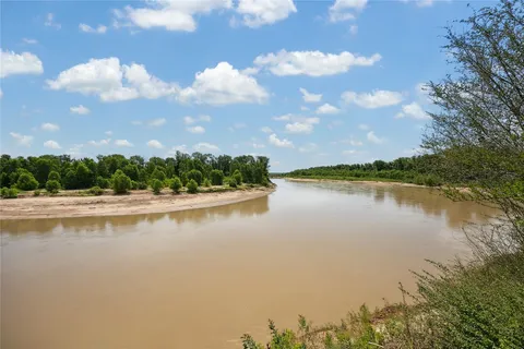 a view of a lake with houses in the back