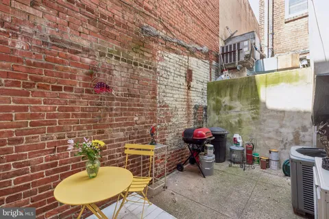 a bathroom with a sink mirror and a toilet