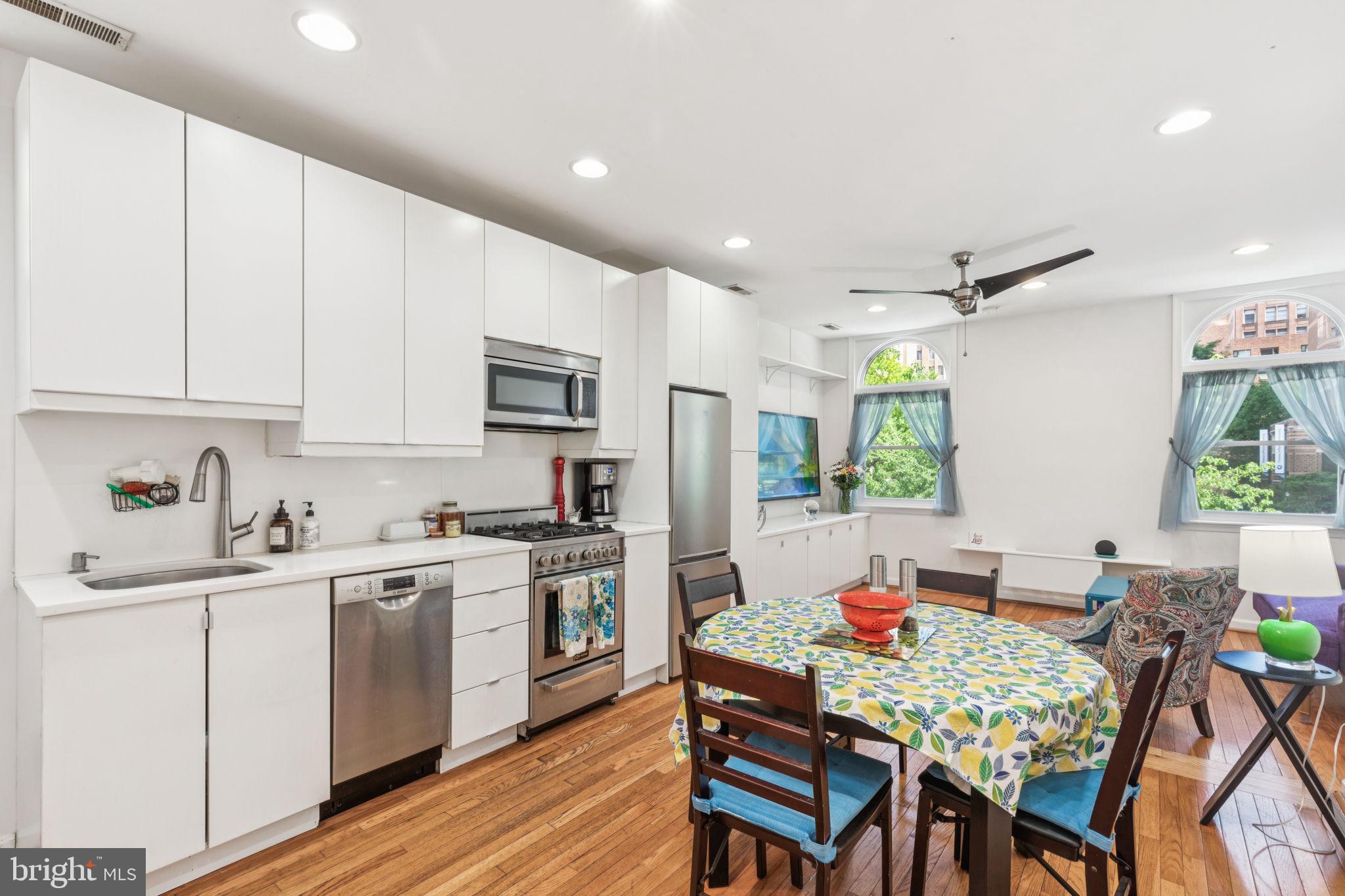 932 Locust Street Philadelphia, PA 19107 - Photo 13 of 23 a kitchen with a table chairs refrigerator and cabinets