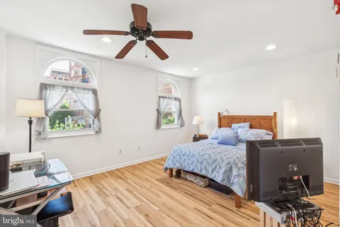 a bedroom with a bed and wooden floor