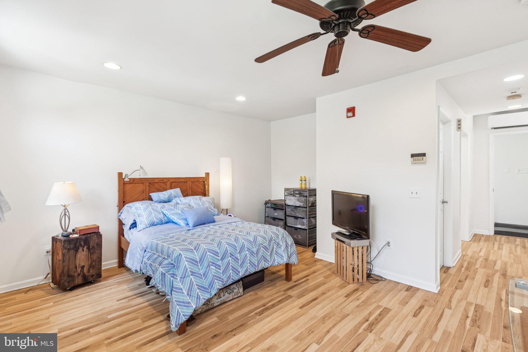 932 Locust Street Philadelphia, PA 19107 - Photo 18 of 23 a bedroom with a bed and wooden floor