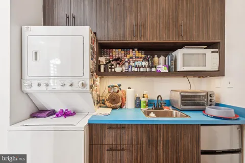 a kitchen with a stove a microwave a refrigerator and cabinets