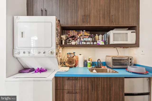 a kitchen with a stove a microwave a refrigerator and cabinets