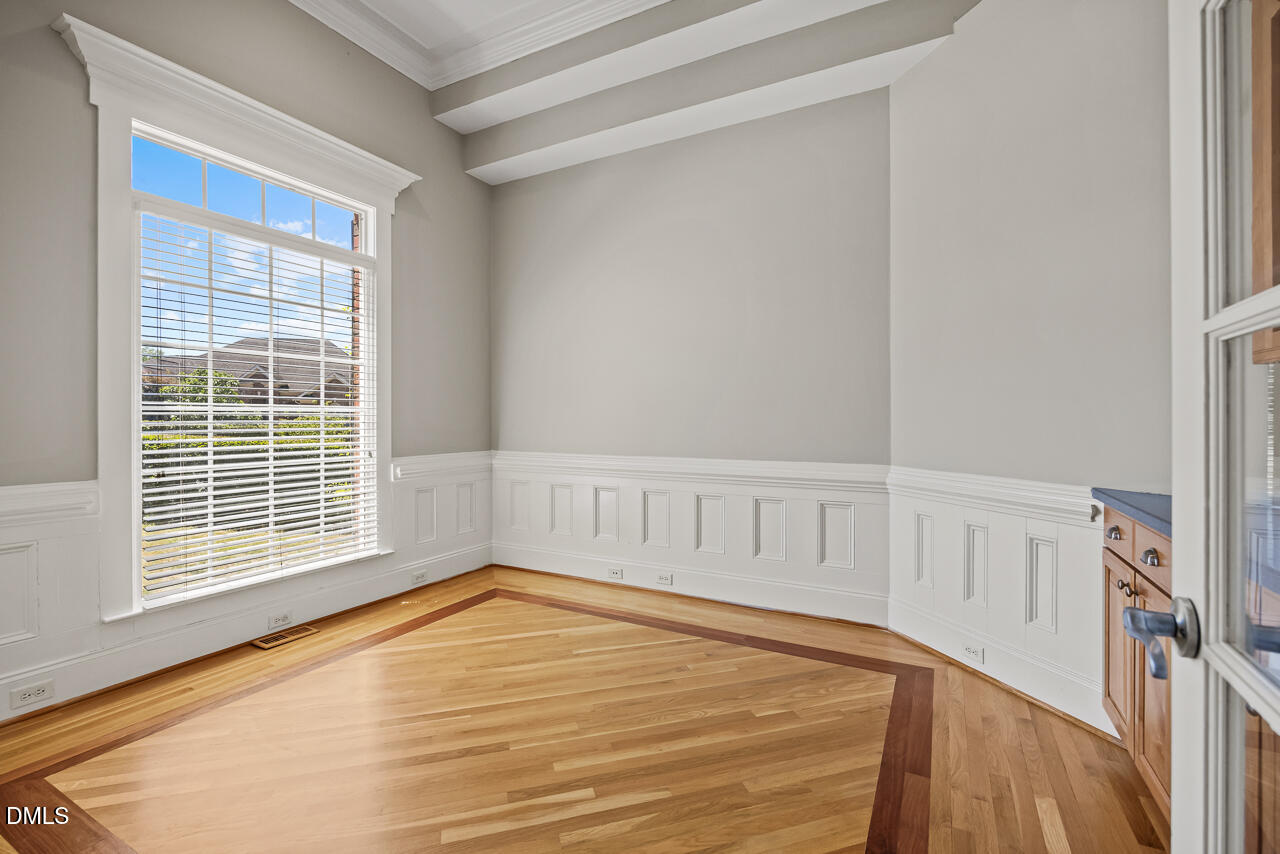 4004 Frontenac Court Apex, NC 27539 - Photo 8 of 61 a view of an empty room with wooden floor and a window