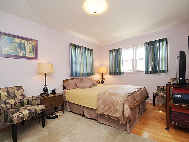 739 Juniper Road Glenview, IL 60025 - Photo 11 of 21 a bedroom with a bed and wooden floor