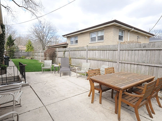 739 Juniper Road Glenview, IL 60025 - Photo 19 of 21 a backyard of a house with barbeque oven table and chairs