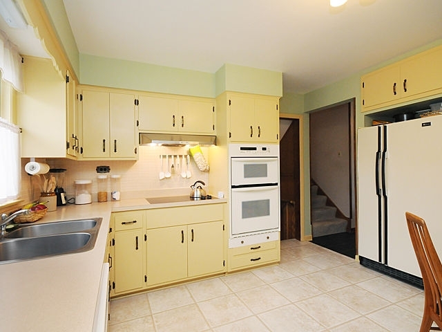 739 Juniper Road Glenview, IL 60025 - Photo 9 of 21 a kitchen with stainless steel appliances a stove a sink and a refrigerator