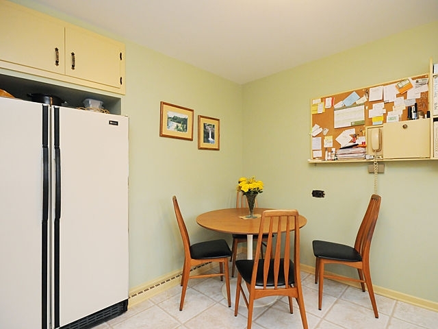 739 Juniper Road Glenview, IL 60025 - Photo 10 of 21 a view of a dining room with furniture and wooden floor