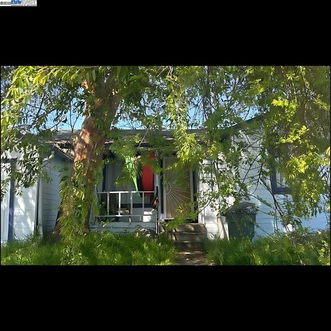 a view of a house with a tree in the background