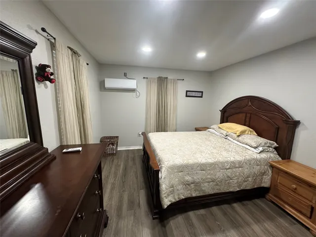 a bedroom with a bed and a dresser