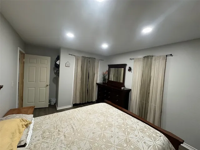 a bedroom with a bed and a dresser