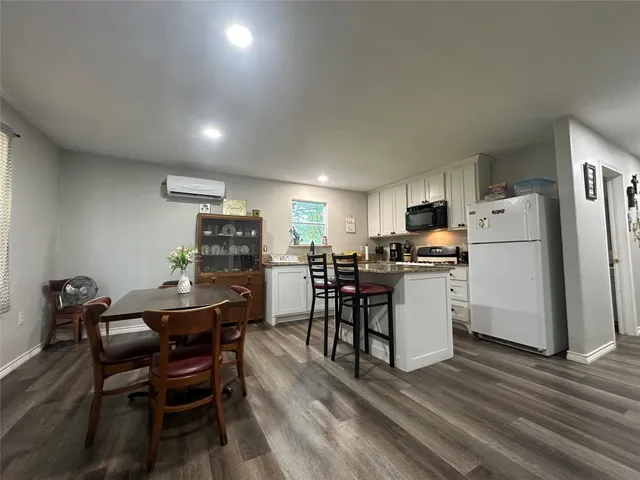 a view of kitchen with furniture and wooden floor