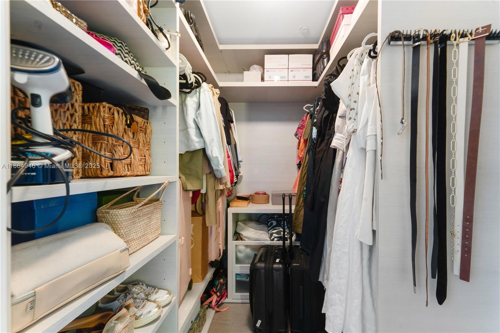 88 Southwest 7th Street, Unit 2910 Miami, FL 33130 - Photo 13 of 22 a view of walk in closet with clothes and shoes