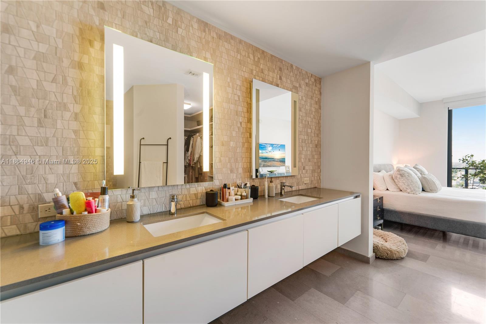 88 Southwest 7th Street, Unit 2910 Miami, FL 33130 - Photo 15 of 22 a spacious bathroom with sinks mirror and a bathtub