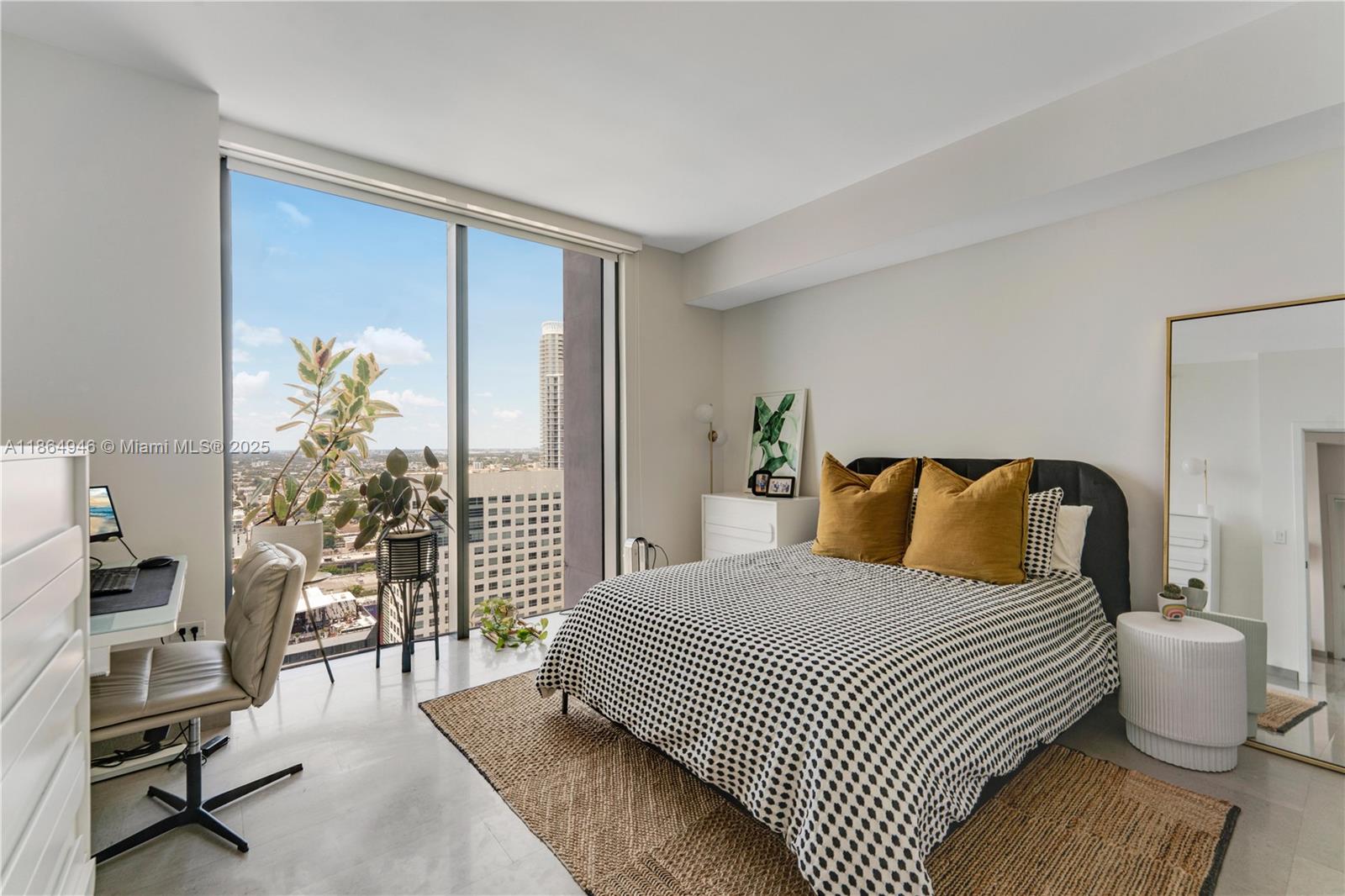 88 Southwest 7th Street, Unit 2910 Miami, FL 33130 - Photo 8 of 22 a bedroom with a bed and a large window