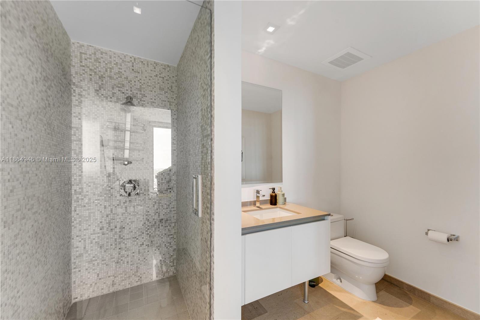 88 Southwest 7th Street, Unit 2910 Miami, FL 33130 - Photo 10 of 22 a bathroom with a toilet a sink and shower