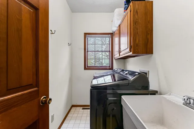 a large bed sitting in a bedroom next to a window