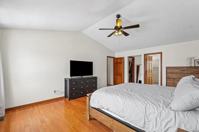 a bathroom with a tub a double vanity sink and a large mirror