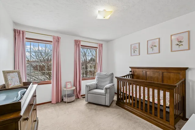 a bedroom with bed and a window