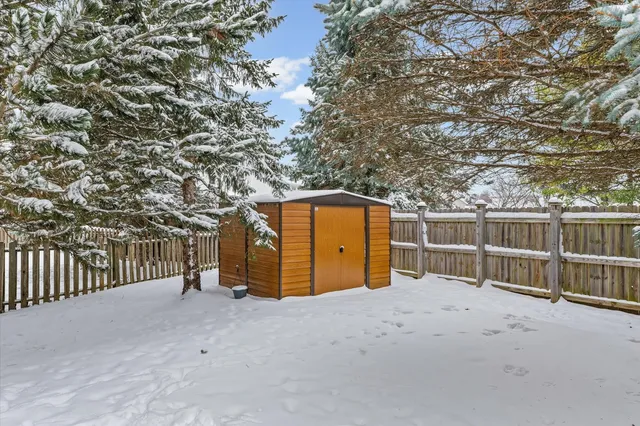 a picture of a room with a white wall and white refrigerator