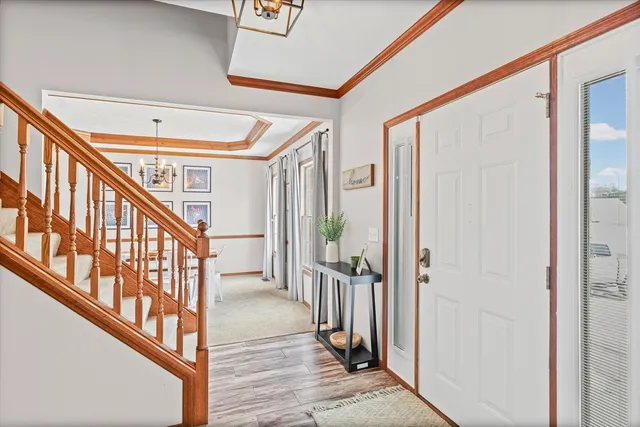 a view of an entryway with wooden floor and stairs