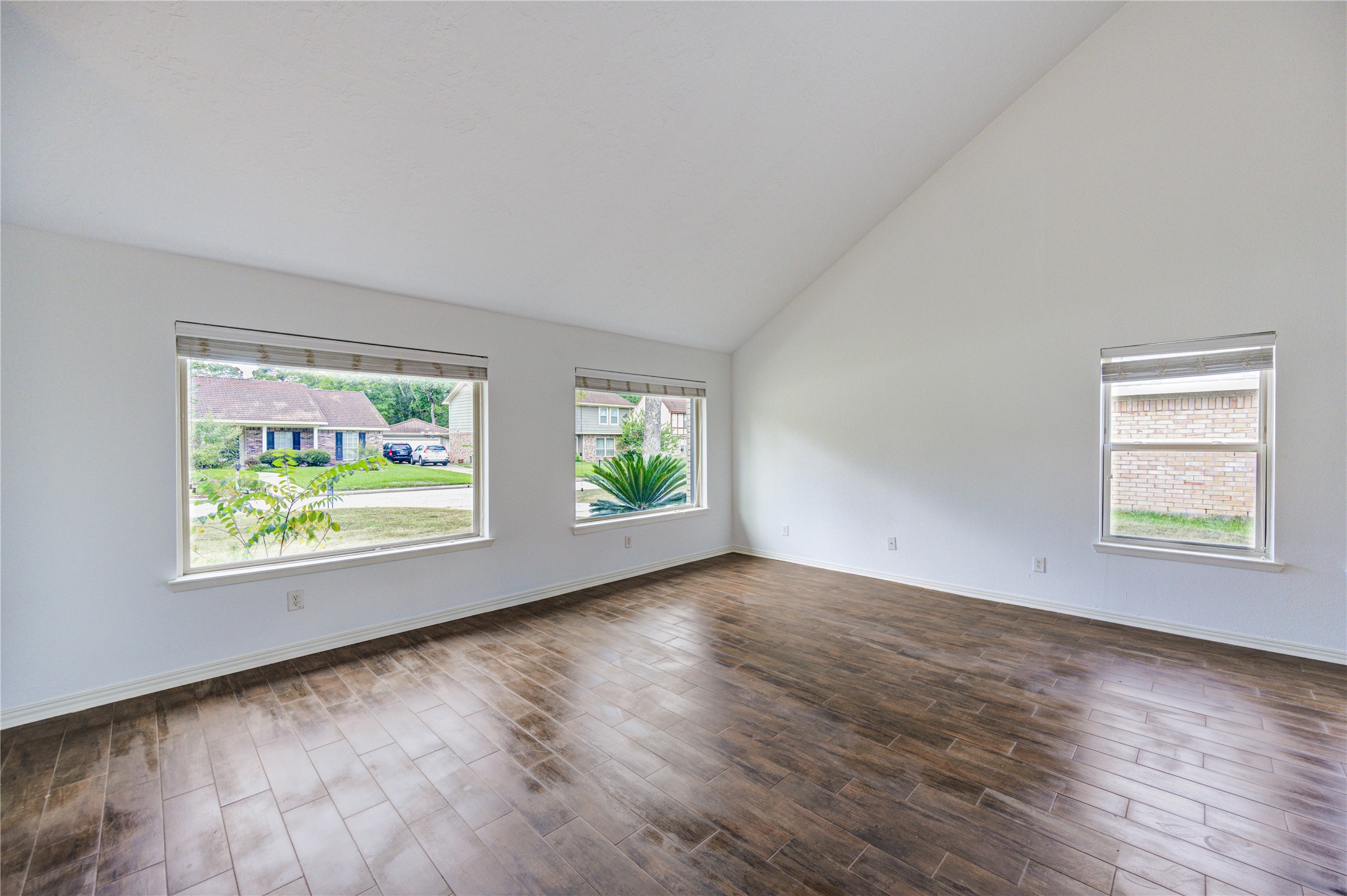 3639 Fir Forest Drive Spring, TX 77388 - Photo 12 of 44 an empty room with wooden floor and windows