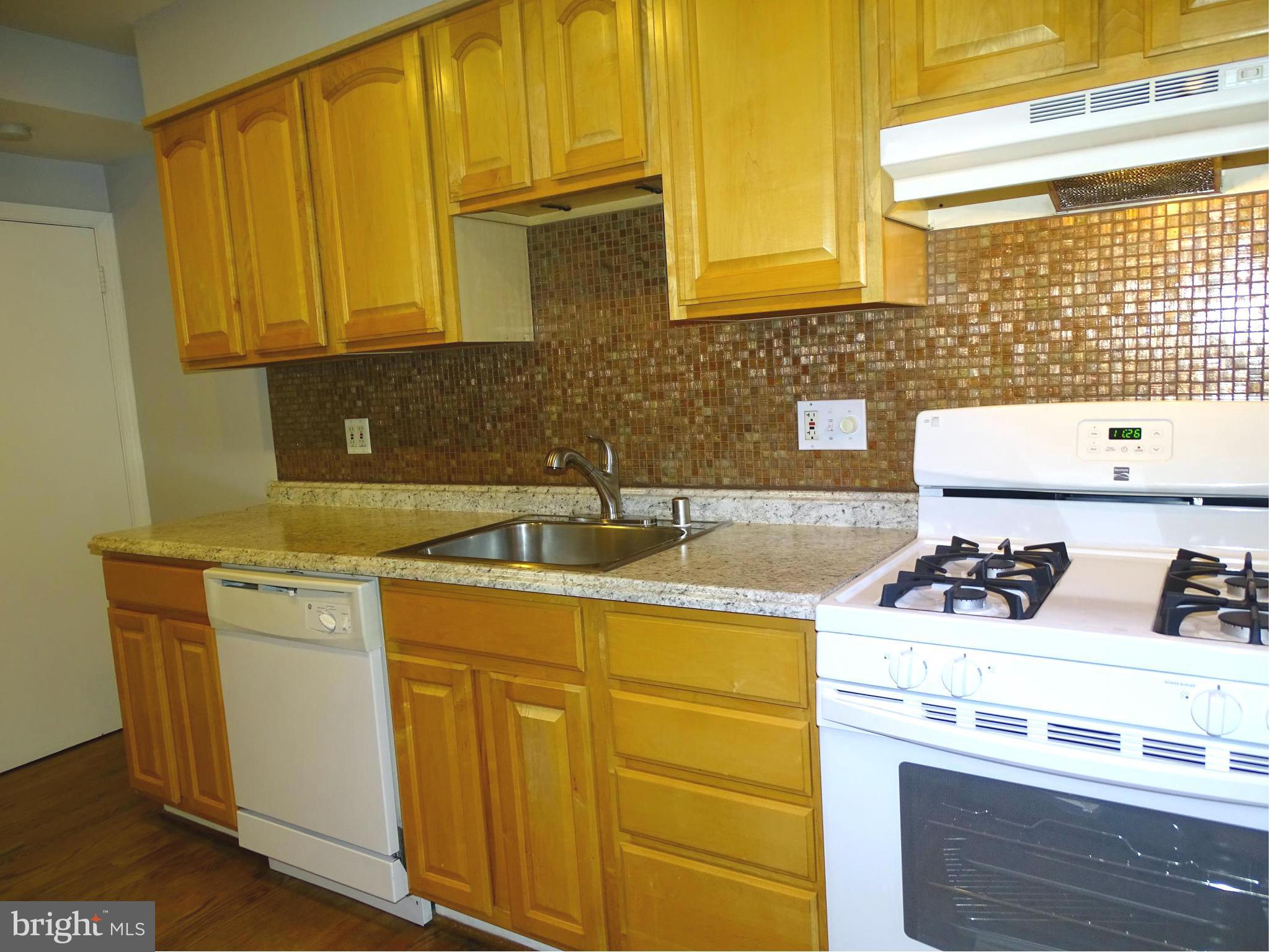 6106 Mt Ridge Road Catonsville, MD 21228 - Photo 12 of 30 a kitchen with a sink stove and cabinets