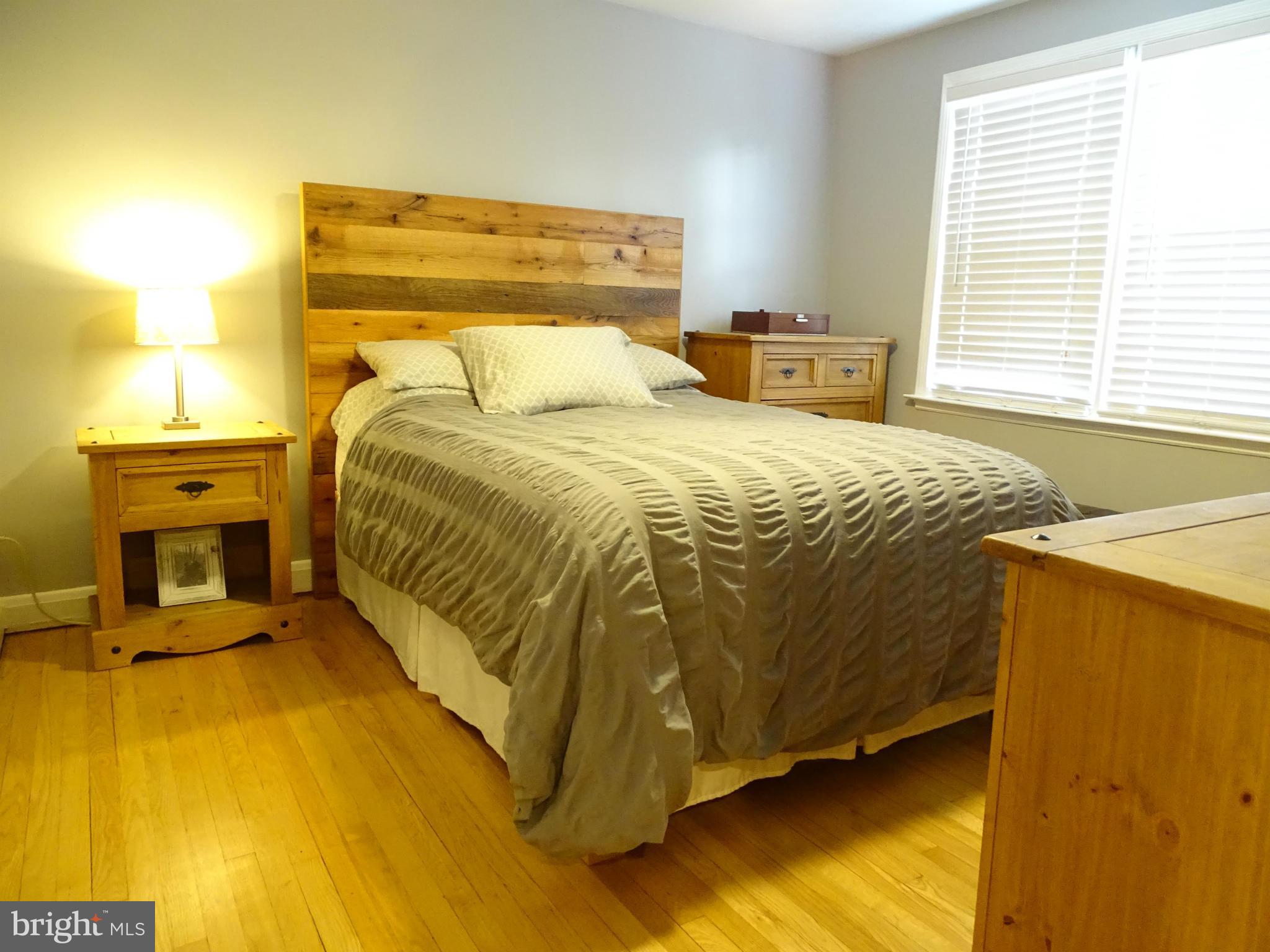 6106 Mt Ridge Road Catonsville, MD 21228 - Photo 13 of 30 a bedroom with a bed and wooden floor