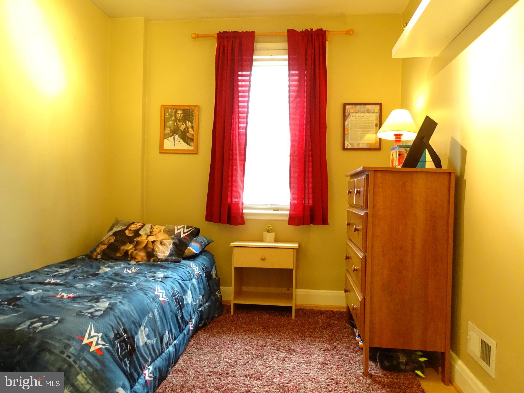 6106 Mt Ridge Road Catonsville, MD 21228 - Photo 15 of 30 a bed sitting in a bedroom next to a window