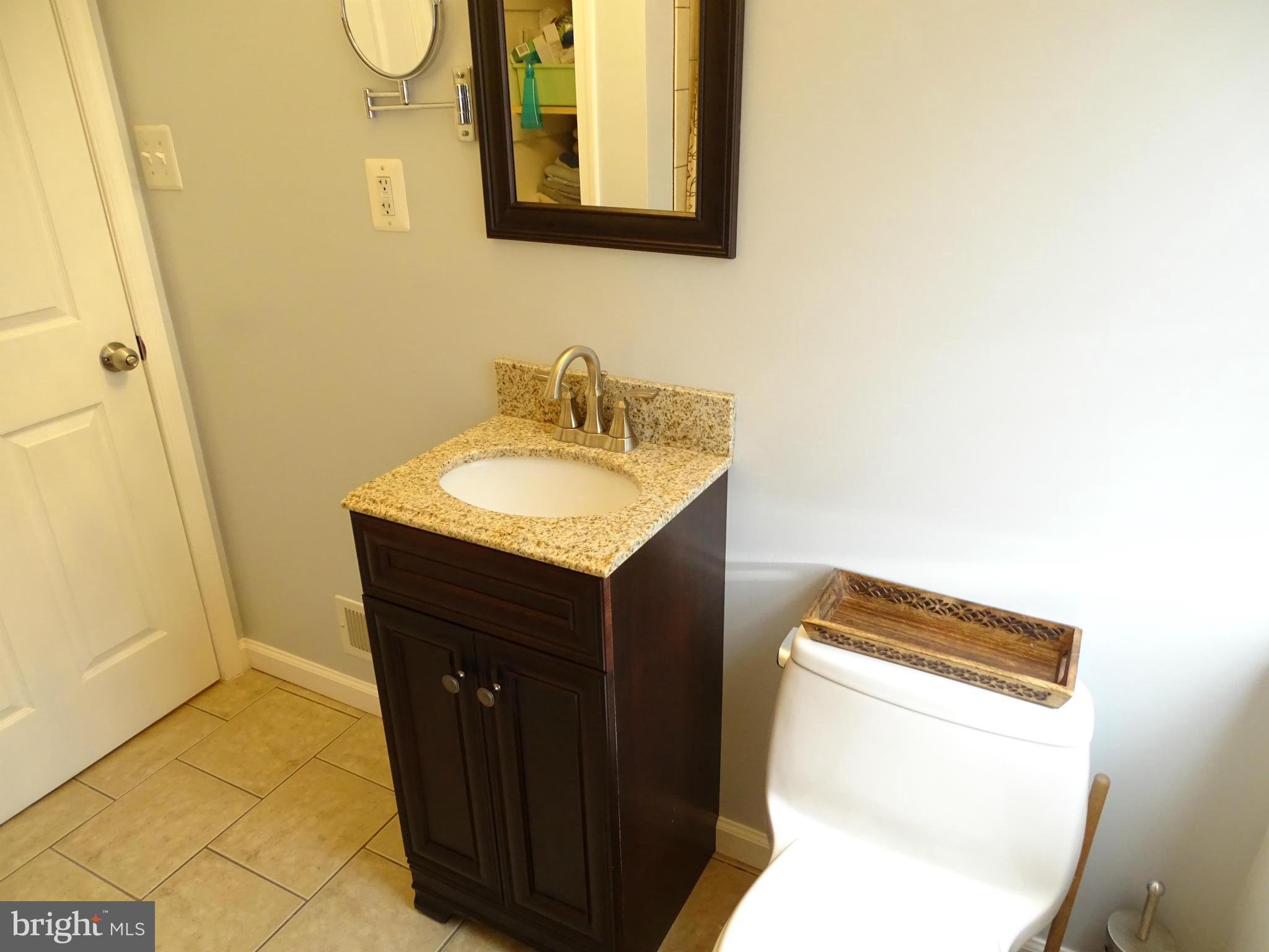 6106 Mt Ridge Road Catonsville, MD 21228 - Photo 19 of 30 a bathroom with a sink and a mirror