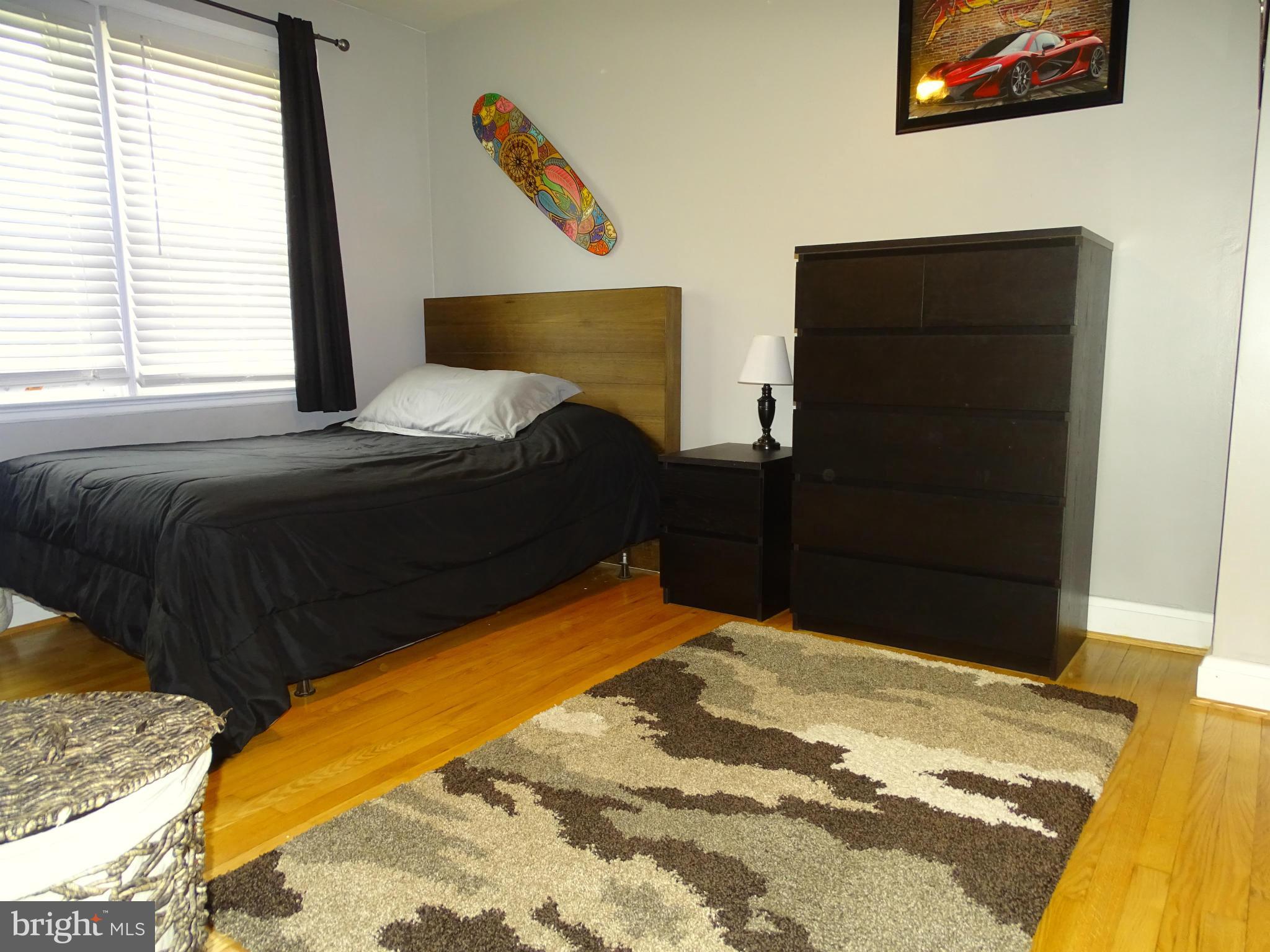 6106 Mt Ridge Road Catonsville, MD 21228 - Photo 20 of 30 a bed sitting in a bedroom next to a window