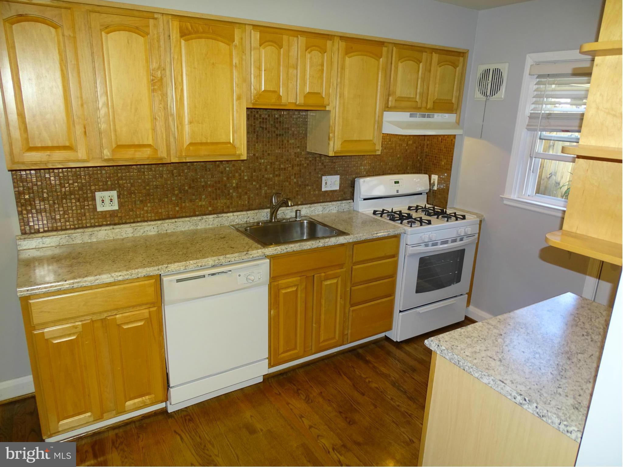 6106 Mt Ridge Road Catonsville, MD 21228 - Photo 4 of 30 a kitchen with stainless steel appliances granite countertop a sink stove and refrigerator