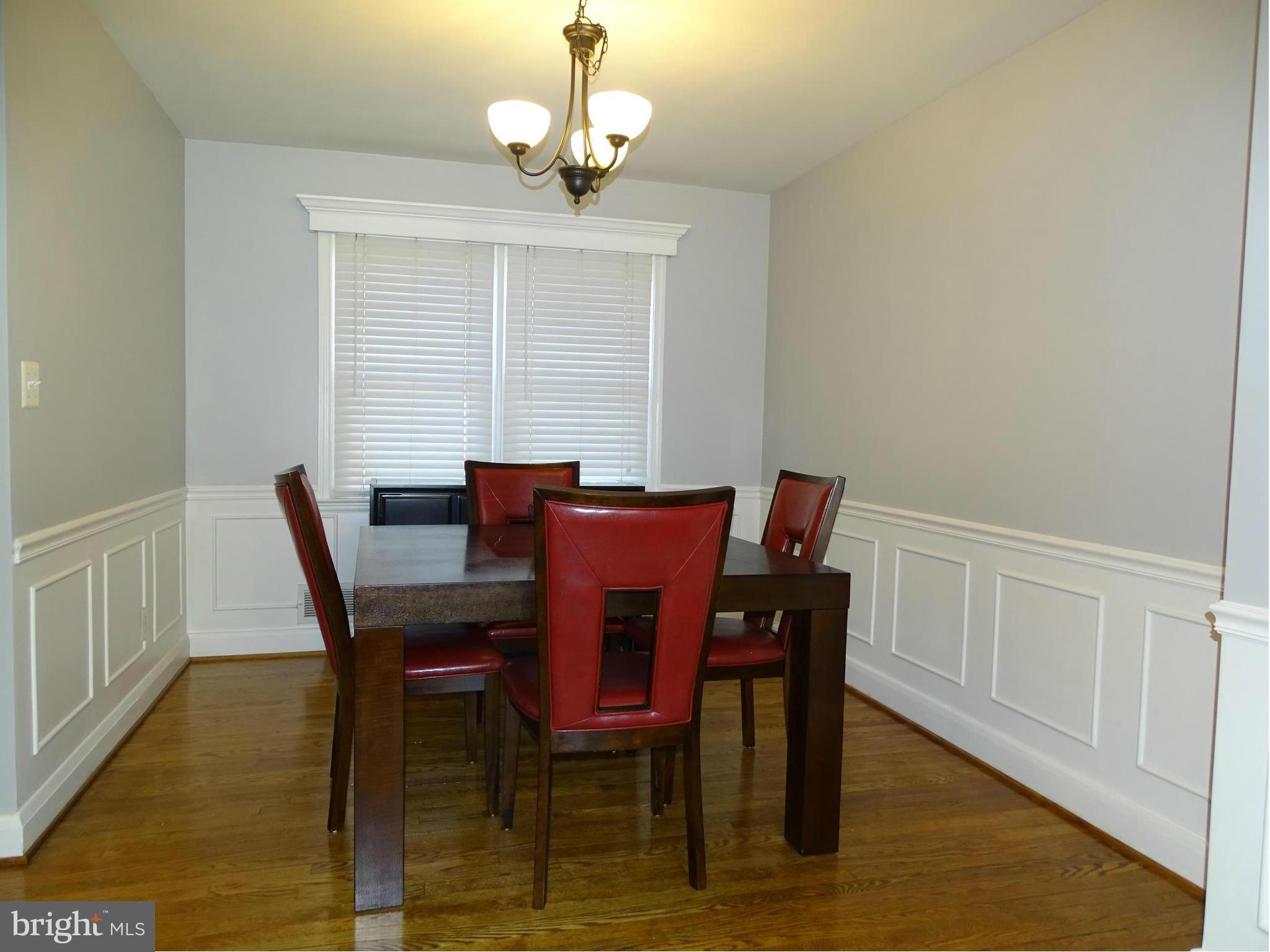 6106 Mt Ridge Road Catonsville, MD 21228 - Photo 7 of 30 a view of a dining room with furniture wooden floor and chandelier