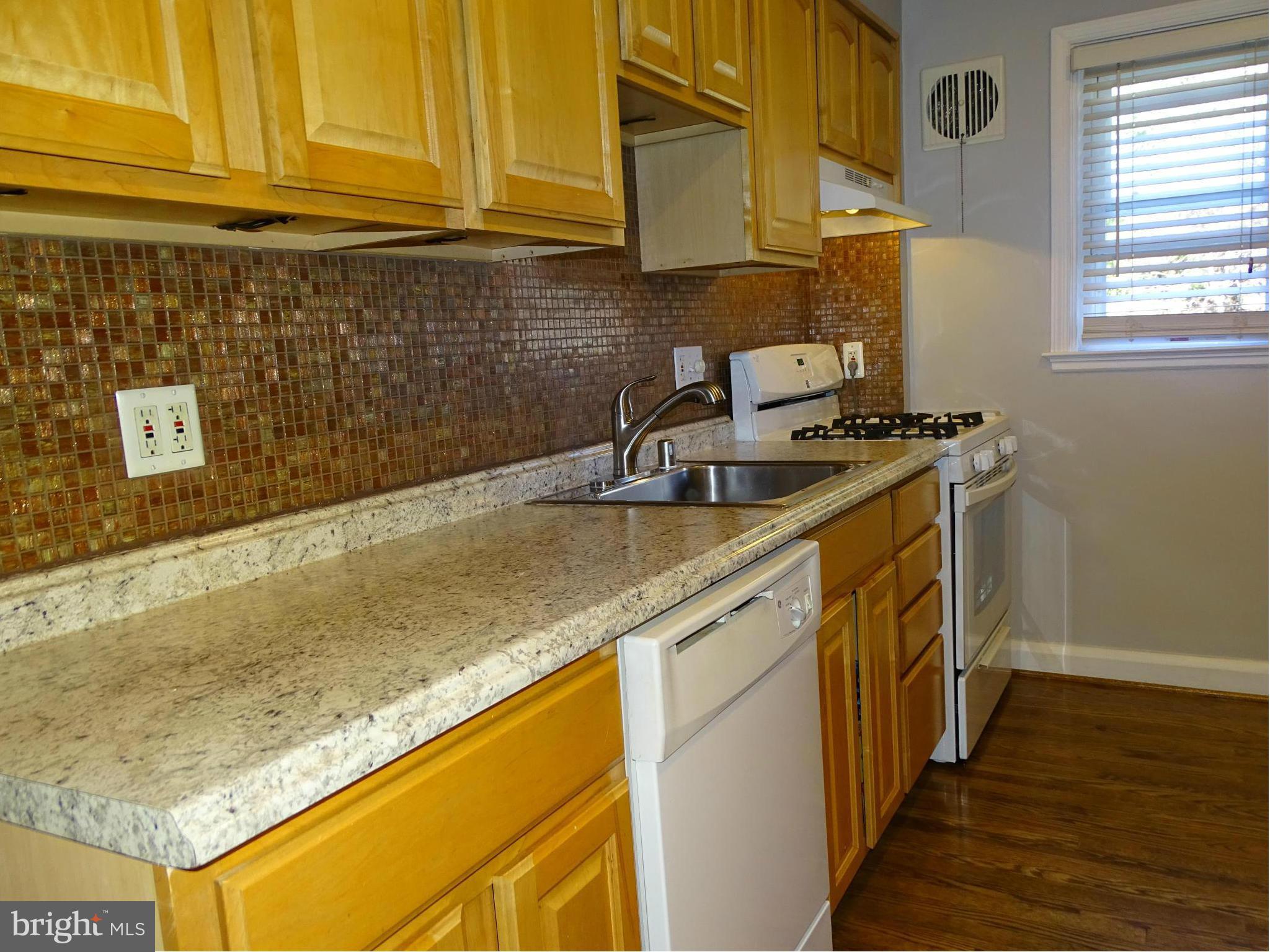 6106 Mt Ridge Road Catonsville, MD 21228 - Photo 8 of 30 a kitchen with granite countertop a sink a stove and cabinets