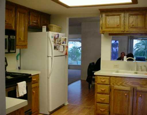 1453 Moore Avenue, Unit C2 Portland, TX 78374 - Photo 4 of 10 a kitchen with a refrigerator and a sink