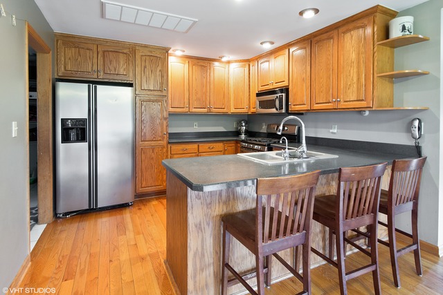 3325 East 19th Road Ottawa, IL 61350 - Photo 5 of 20 a kitchen with stainless steel appliances granite countertop a sink a stove a refrigerator with a dining table and chairs