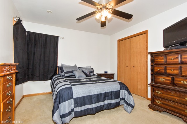 3325 East 19th Road Ottawa, IL 61350 - Photo 8 of 20 a bedroom with a bed and a flat tv screen on dresser
