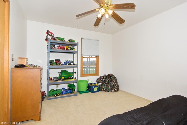 3325 East 19th Road Ottawa, IL 61350 - Photo 9 of 20 a bedroom with a bed and a chandelier