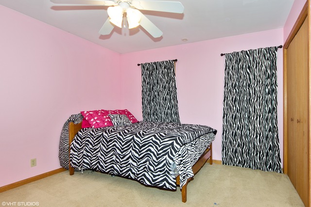 3325 East 19th Road Ottawa, IL 61350 - Photo 10 of 20 a bedroom with a bed and a chandelier