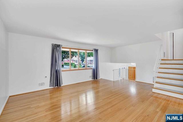 516 Knickerbocker Road Cresskill, NJ 07626 - Photo 11 of 31 a view of a big room with wooden floor and windows