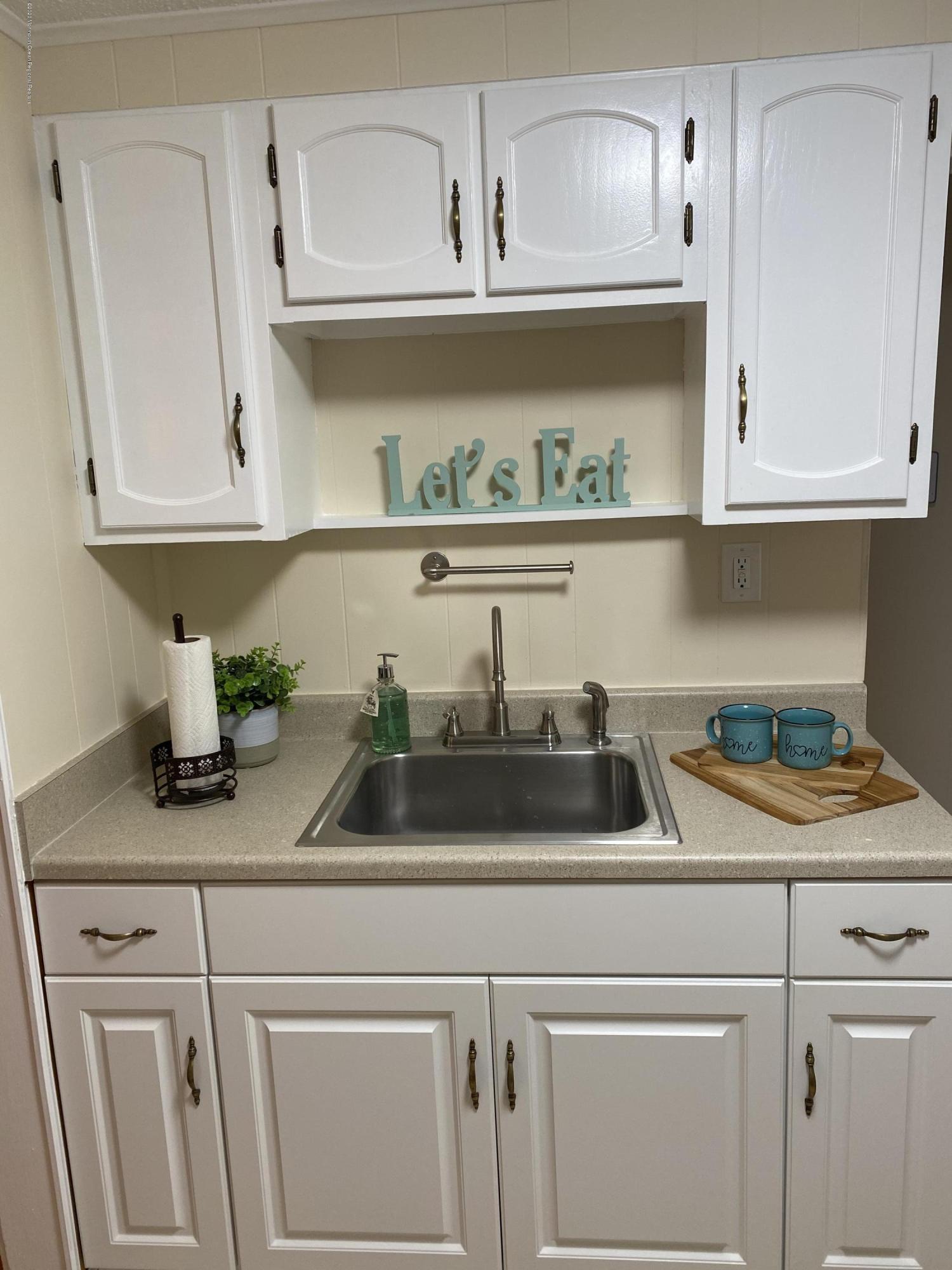 1659 Englishtown Road Old Bridge, NJ 08857 - Photo 8 of 38 a kitchen with white cabinets and a white counter top