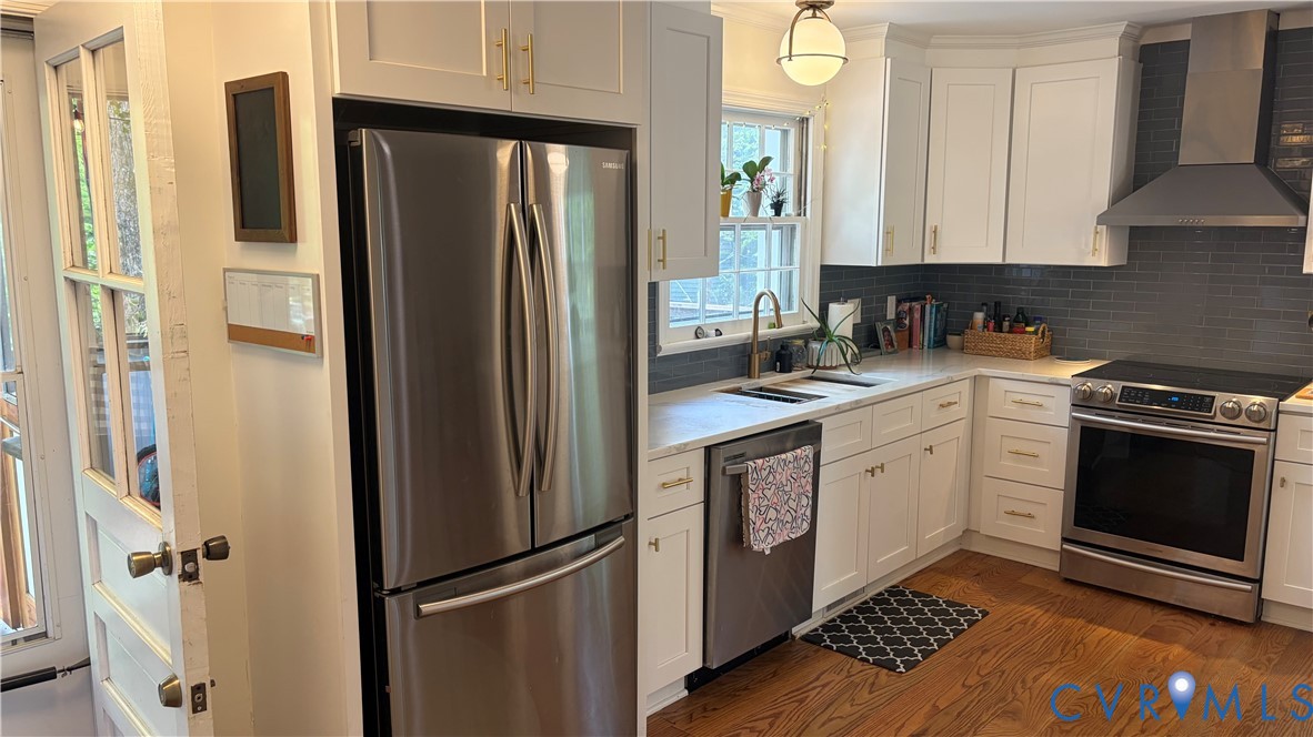 2502 Brookwood Road Richmond, VA 23235 - Photo 16 of 54 a kitchen with a refrigerator sink and cabinets