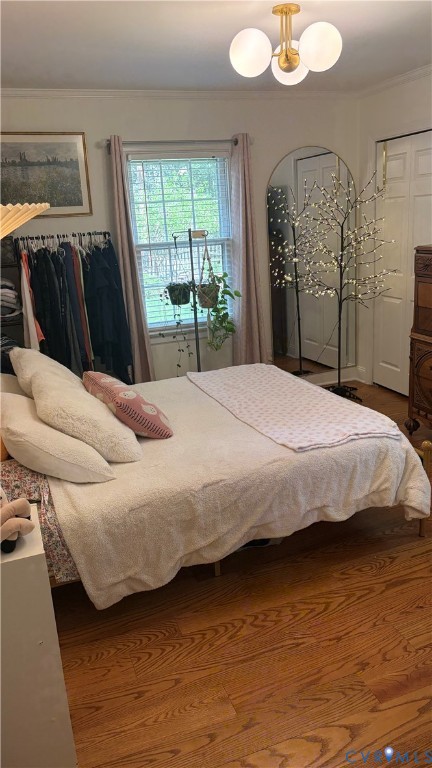 2502 Brookwood Road Richmond, VA 23235 - Photo 34 of 54 a bedroom with a bed and wooden floor