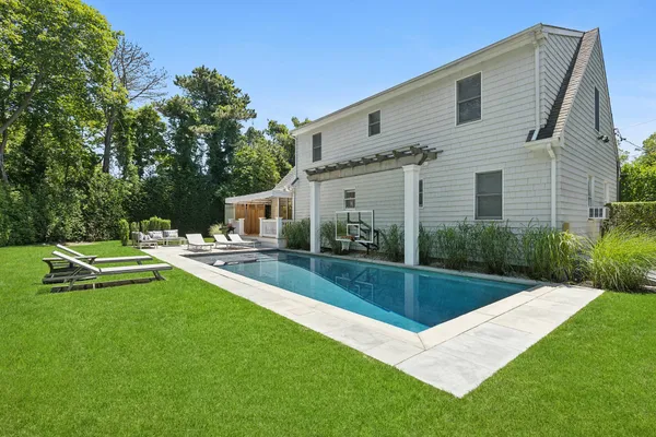 a view of a house with backyard sitting area and garden