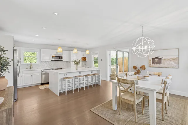 a kitchen with stainless steel appliances kitchen island granite countertop a refrigerator and microwave